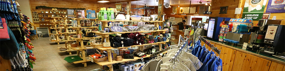 The inside of a small Adirondack store with wooden shelves stocked with local goods