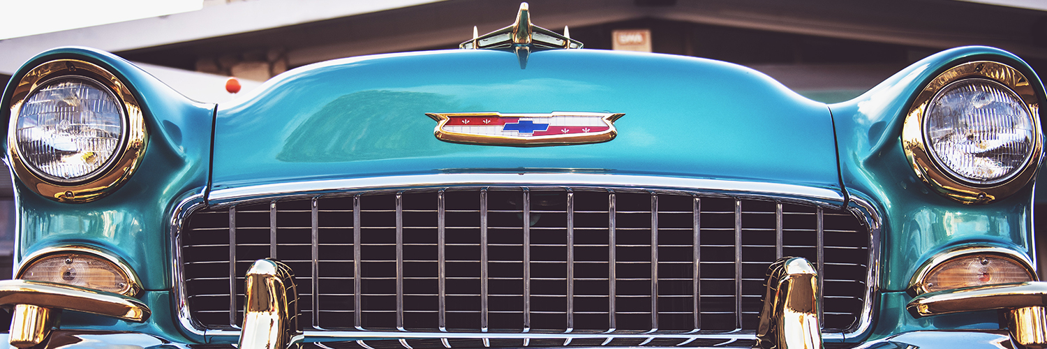 An antique Chevy car. The car is a shiny blue color.