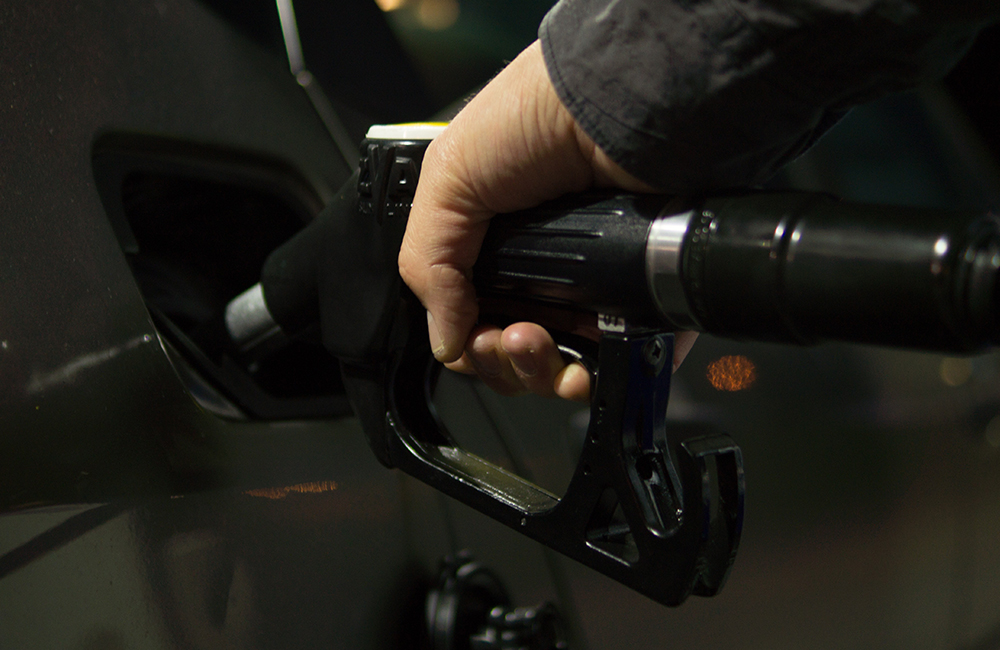 A person pumping gas.