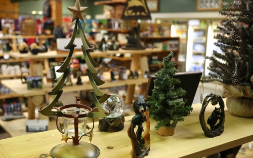 The inside of a small Adirondack store with wooden shelves stocked with local goods