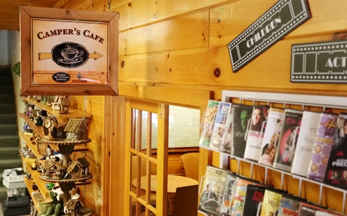 The inside of a small Adirondack store with wooden shelves stocked with local goods