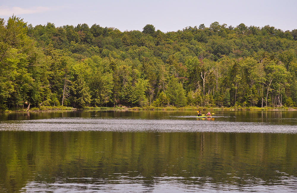 Picture of two people on canoes on Lake Serene.