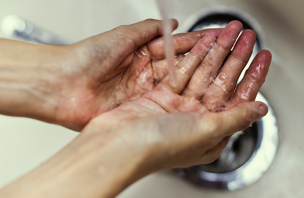 A person washing their hands.