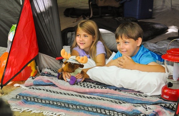 two kids in a tent holding a stuffed Walter safari